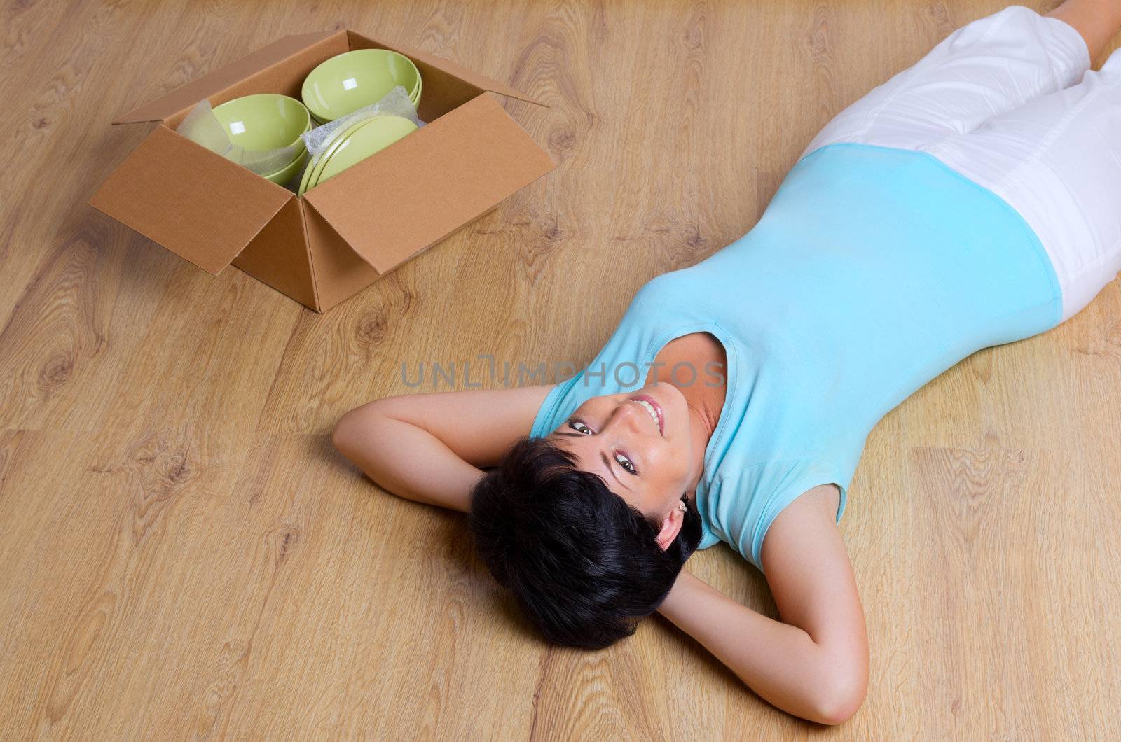 Laying woman and box with dishware