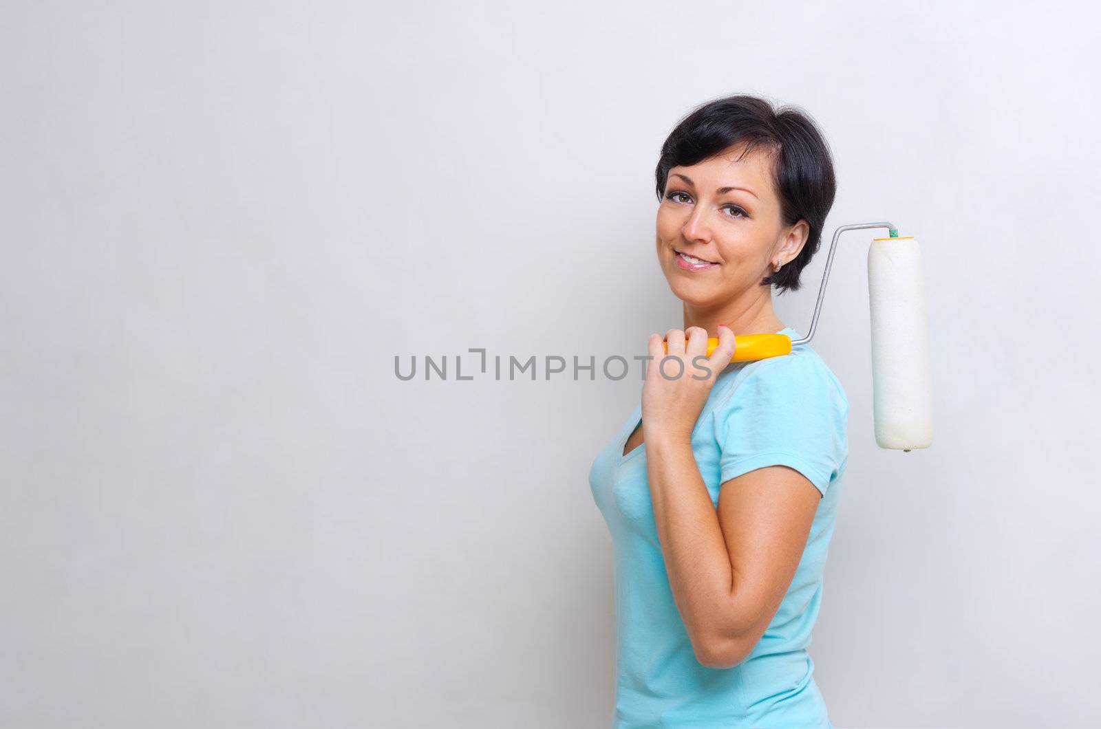 Happy woman with painting roller