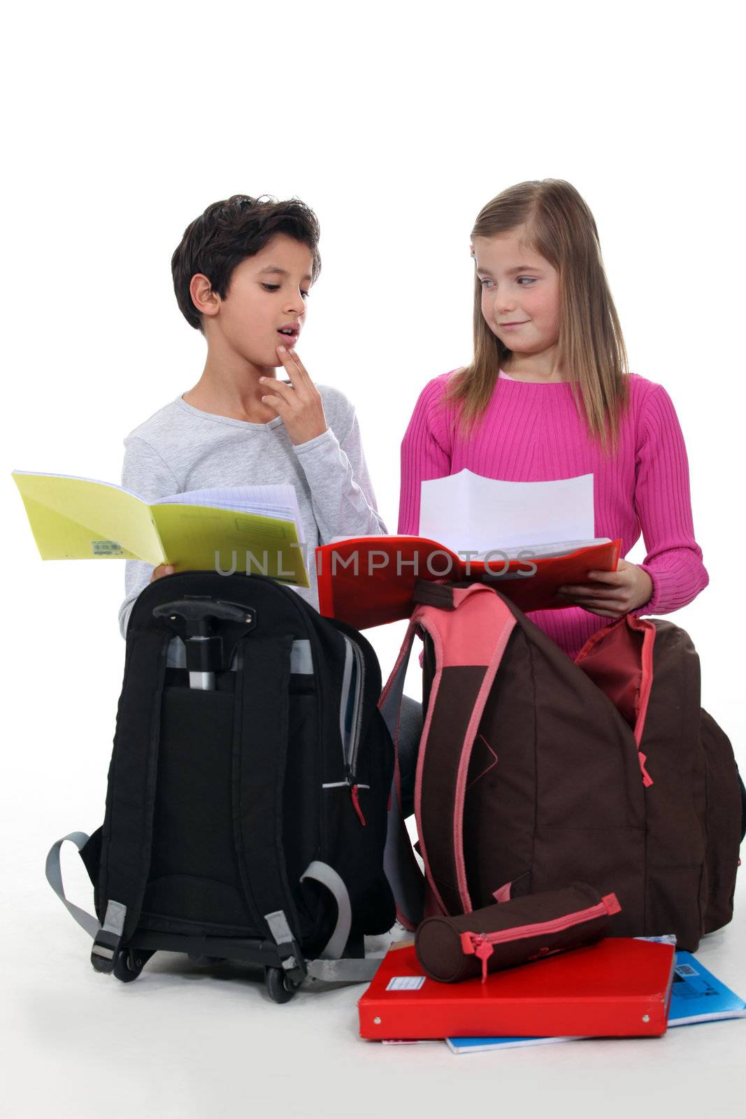 Schoolchildren comparing homework by phovoir