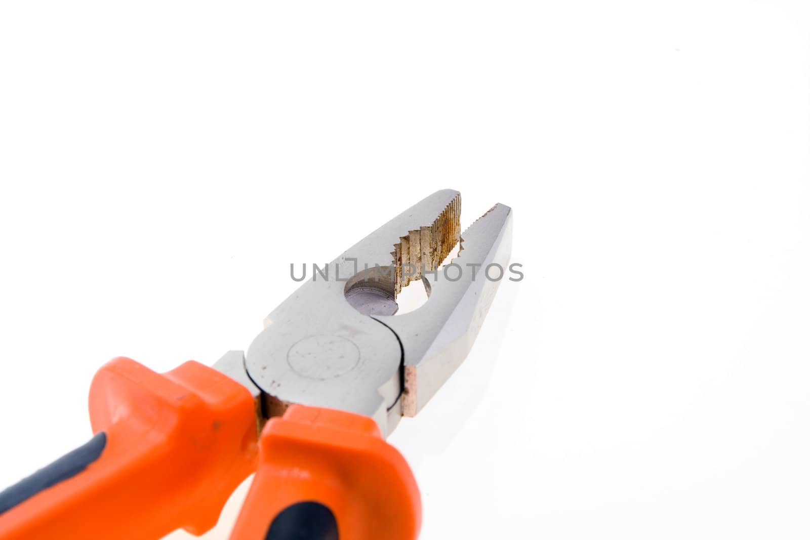 Steel used pliers with plastic color handles on a white background