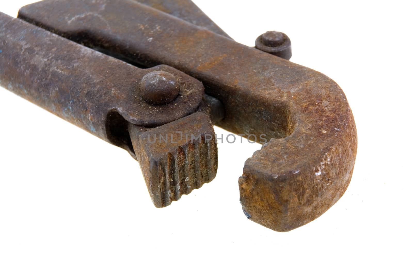 Big used rusty wrench on white background.