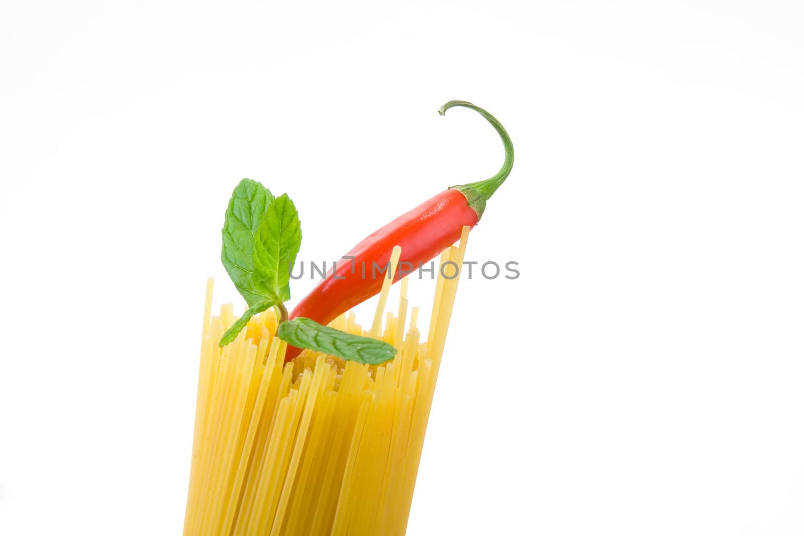 Golden raw dried Italian pasta with other ingredients on white background.