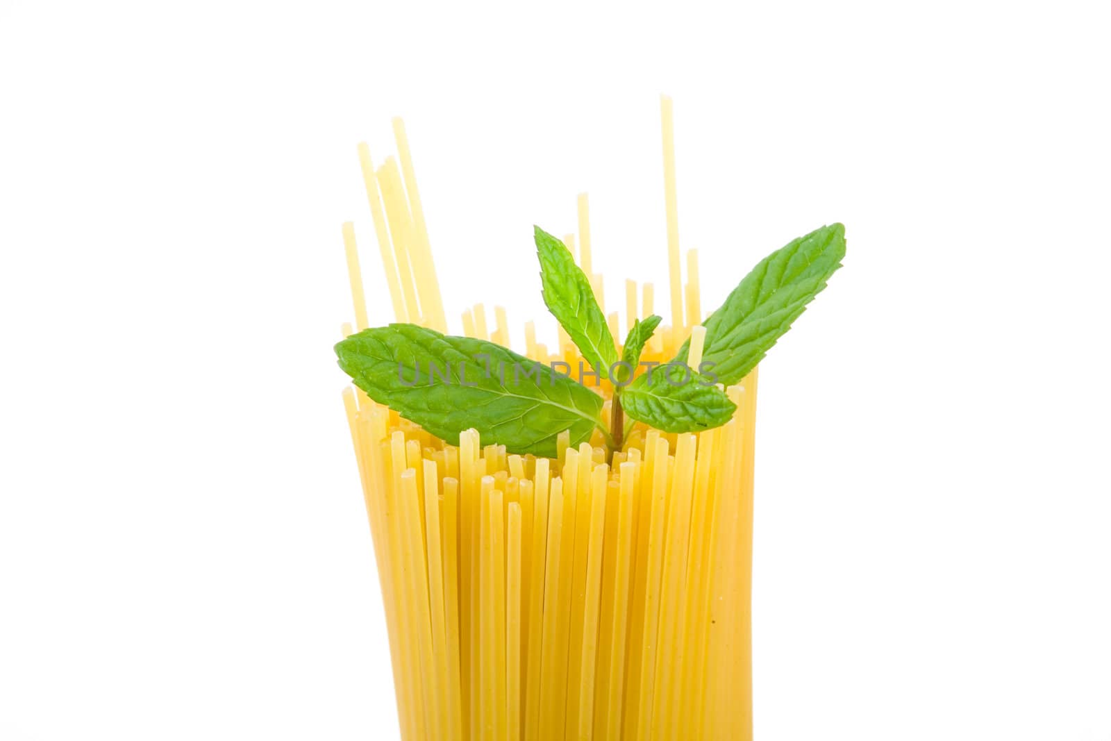 Golden raw dried Italian pasta with other ingredients on white background.