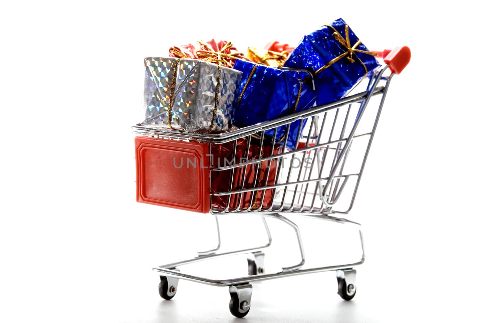 shopping cart with gift box wrapped in colored paper and ribbon on white background