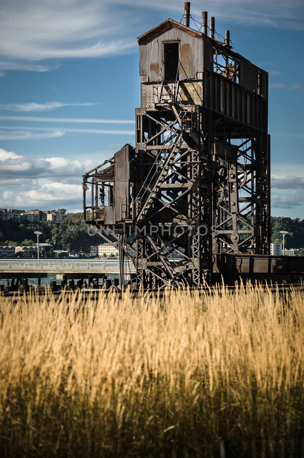 Rusty old shipping terminal with a blue sky by Shane9