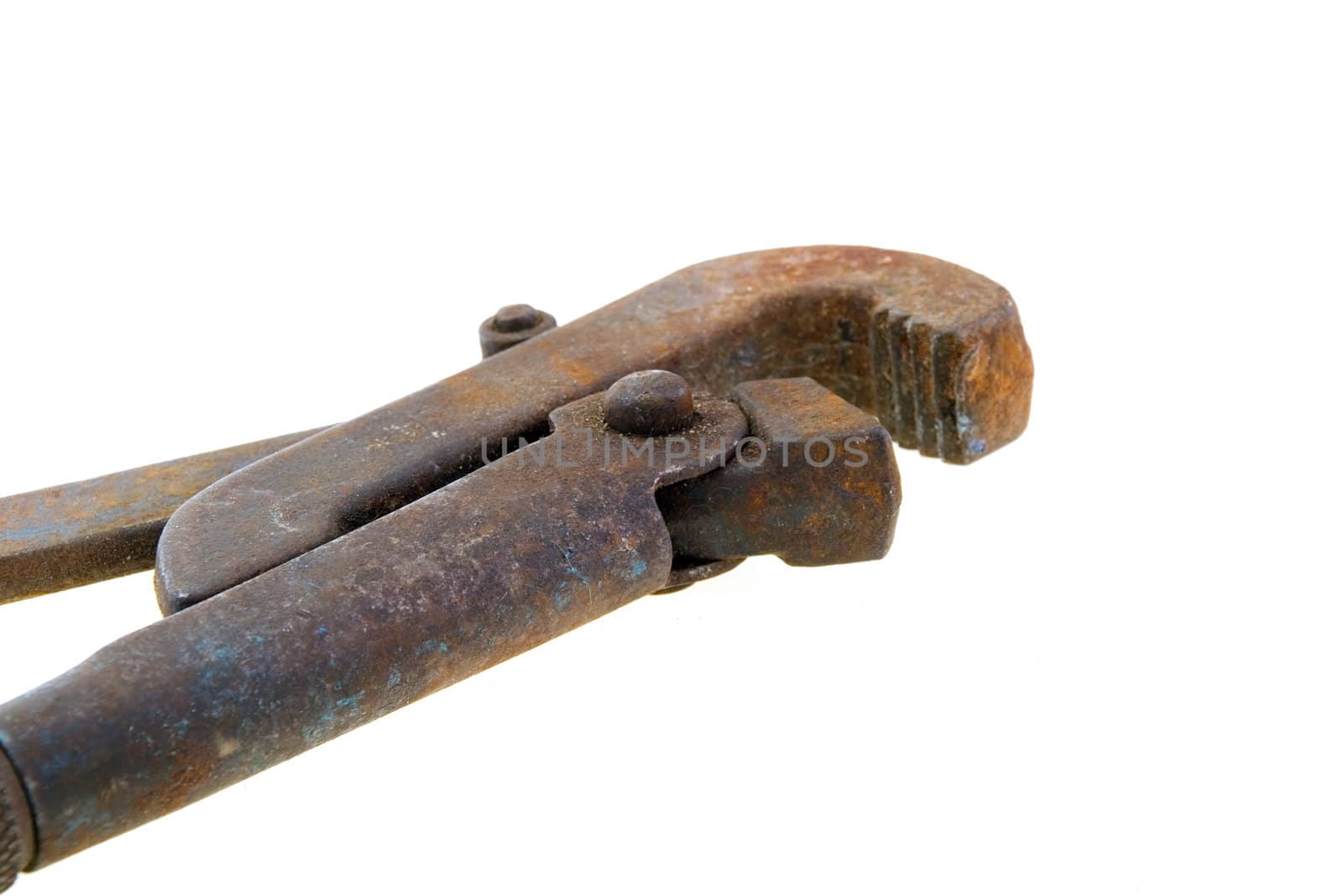 Big used rusty wrench on white background.