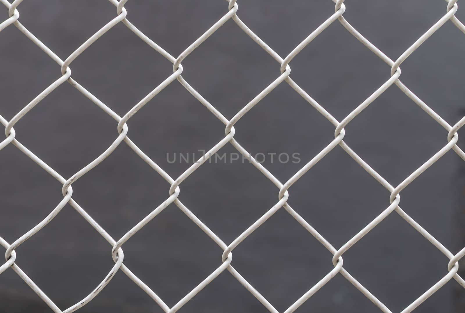 White chain link fence on gray background