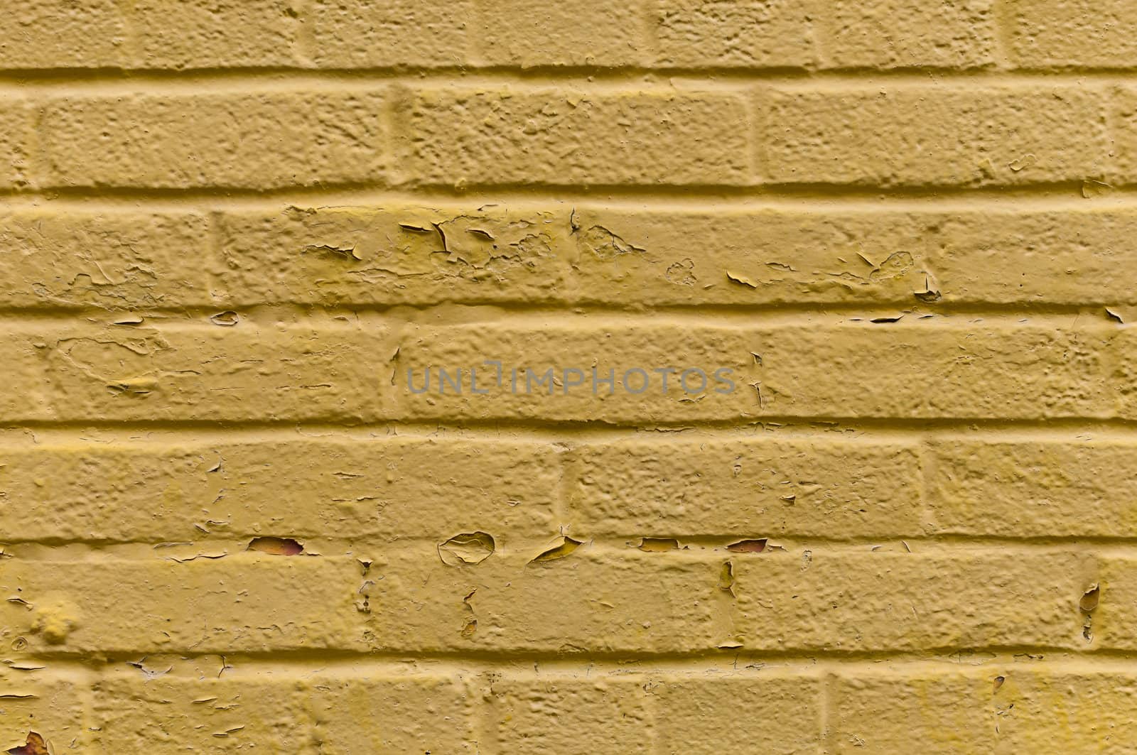 Yellow old painted brick wall background