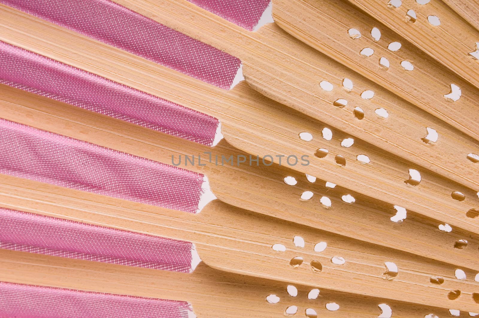 Pink wooden hand made fan on white. by Shane9