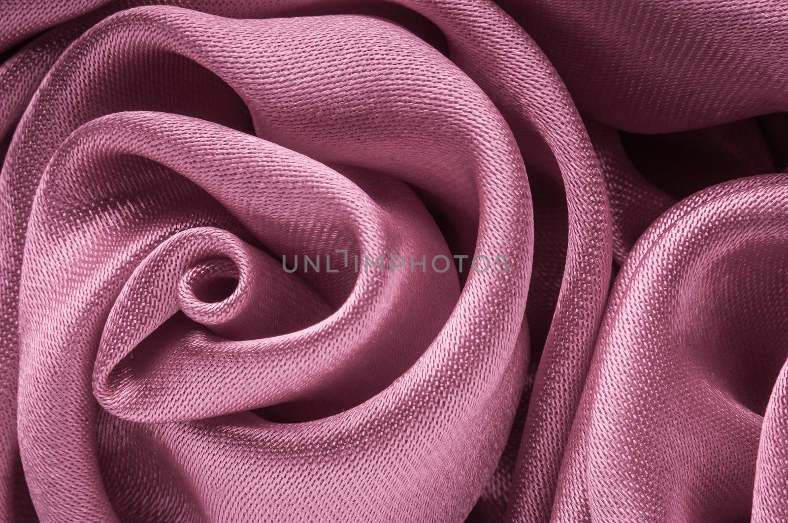 Close up of shiny light purple fabric rose shaped flower.