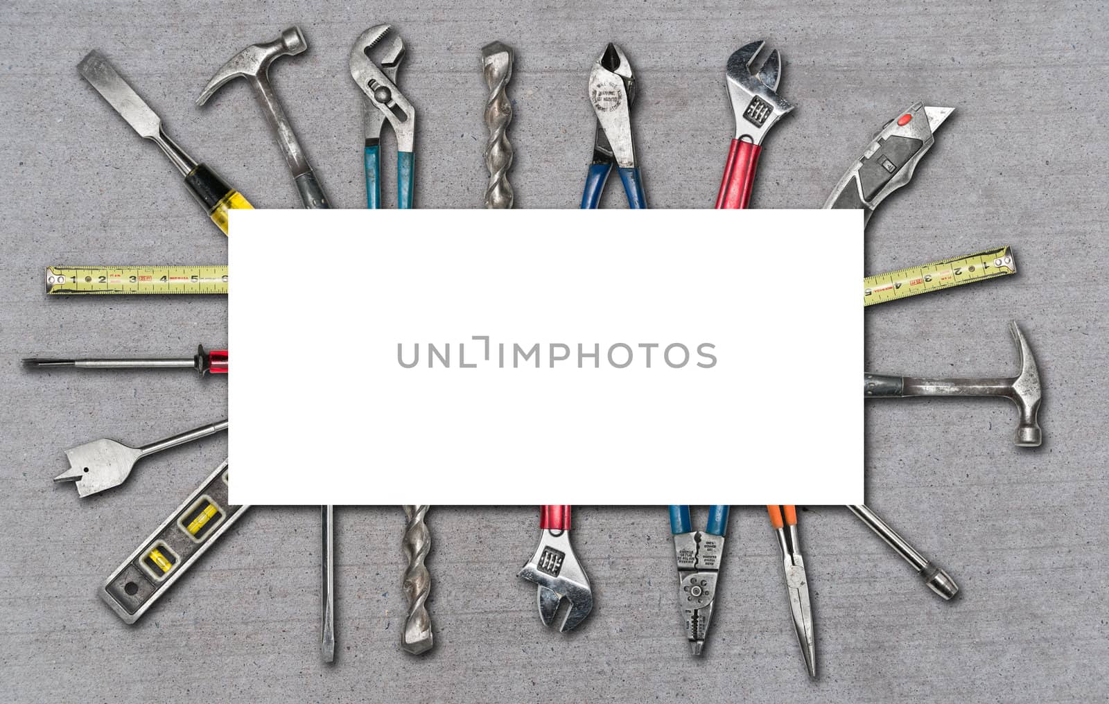 Various used tools on concrete background with white box