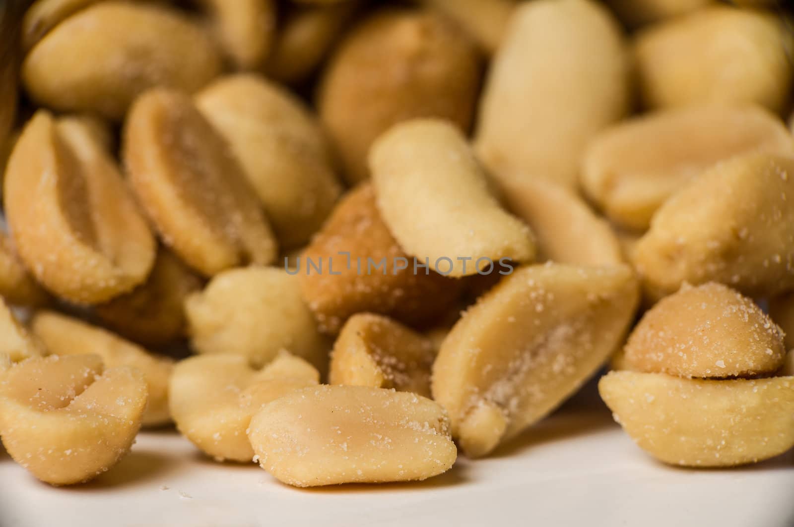 Close up shot of yellow peanuts in a pile.