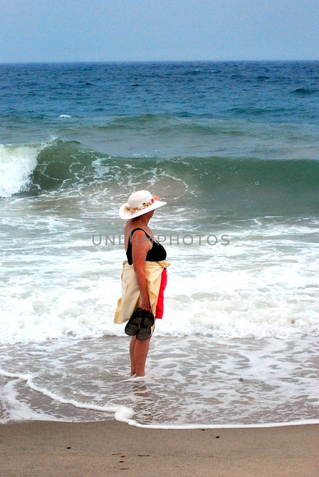 Beachcomber relaxing on the beach outside.