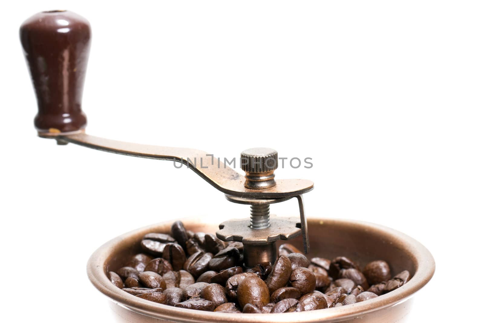 Fresh roasted coffee beans in the manual coffee grinder on white background