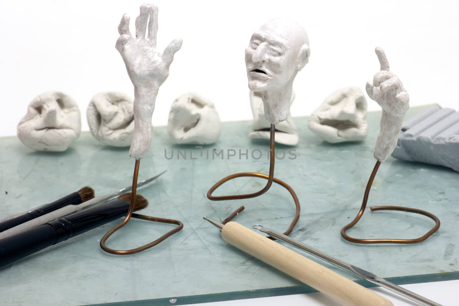 Workplace sculptor miniaturist. Working with polymer clay.