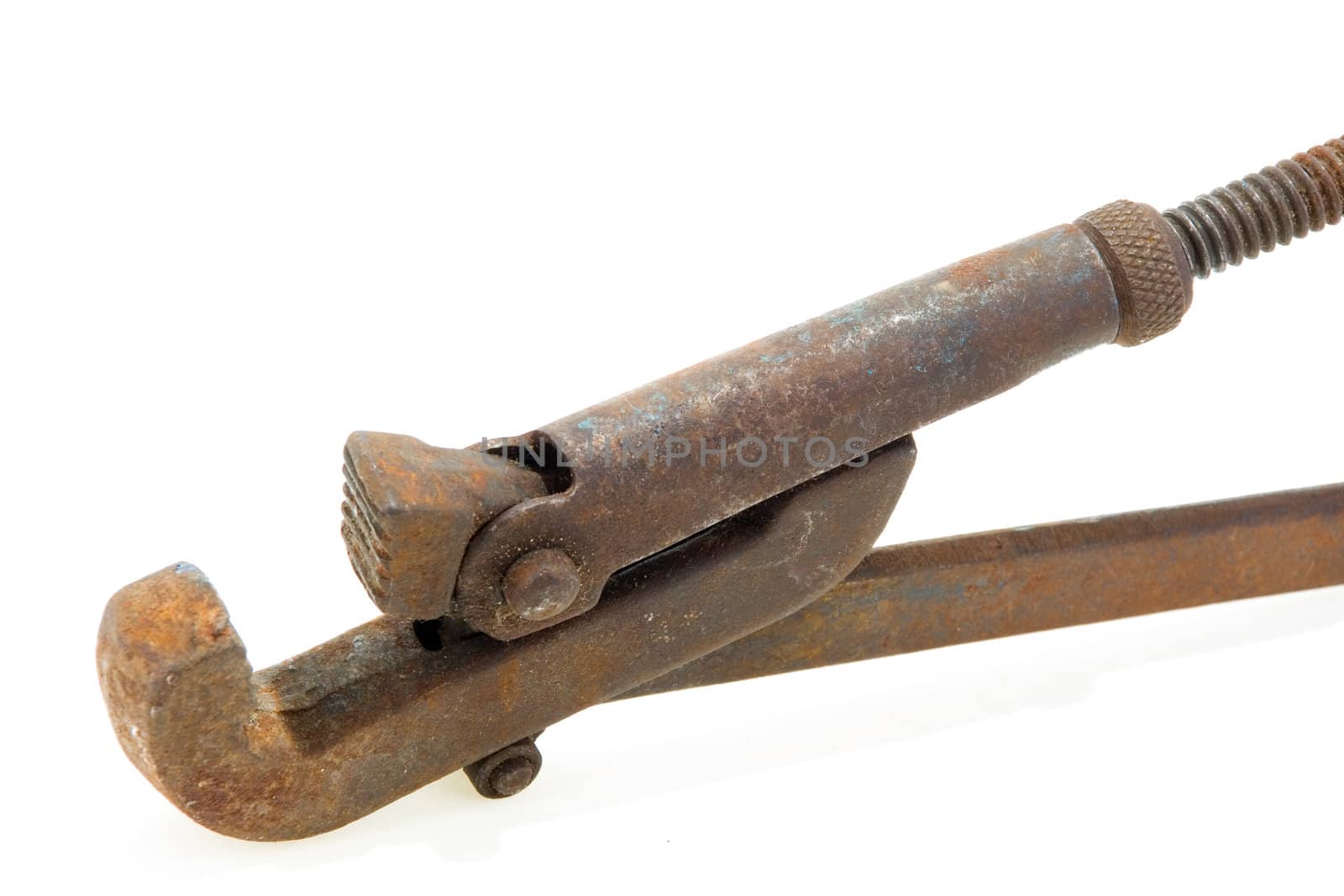 Big used rusty wrench on white background.