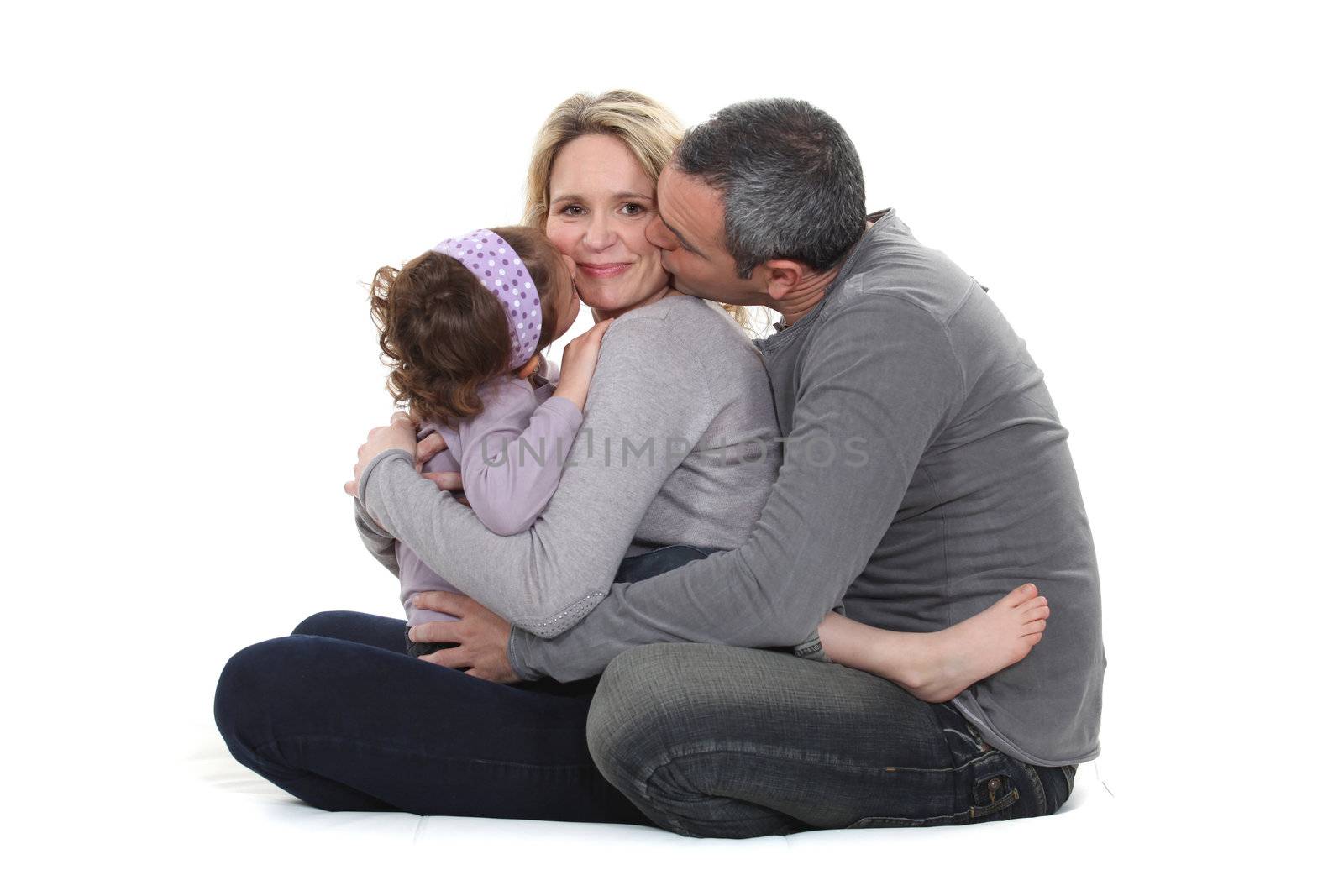 woman posing with loving husband and daughter by phovoir