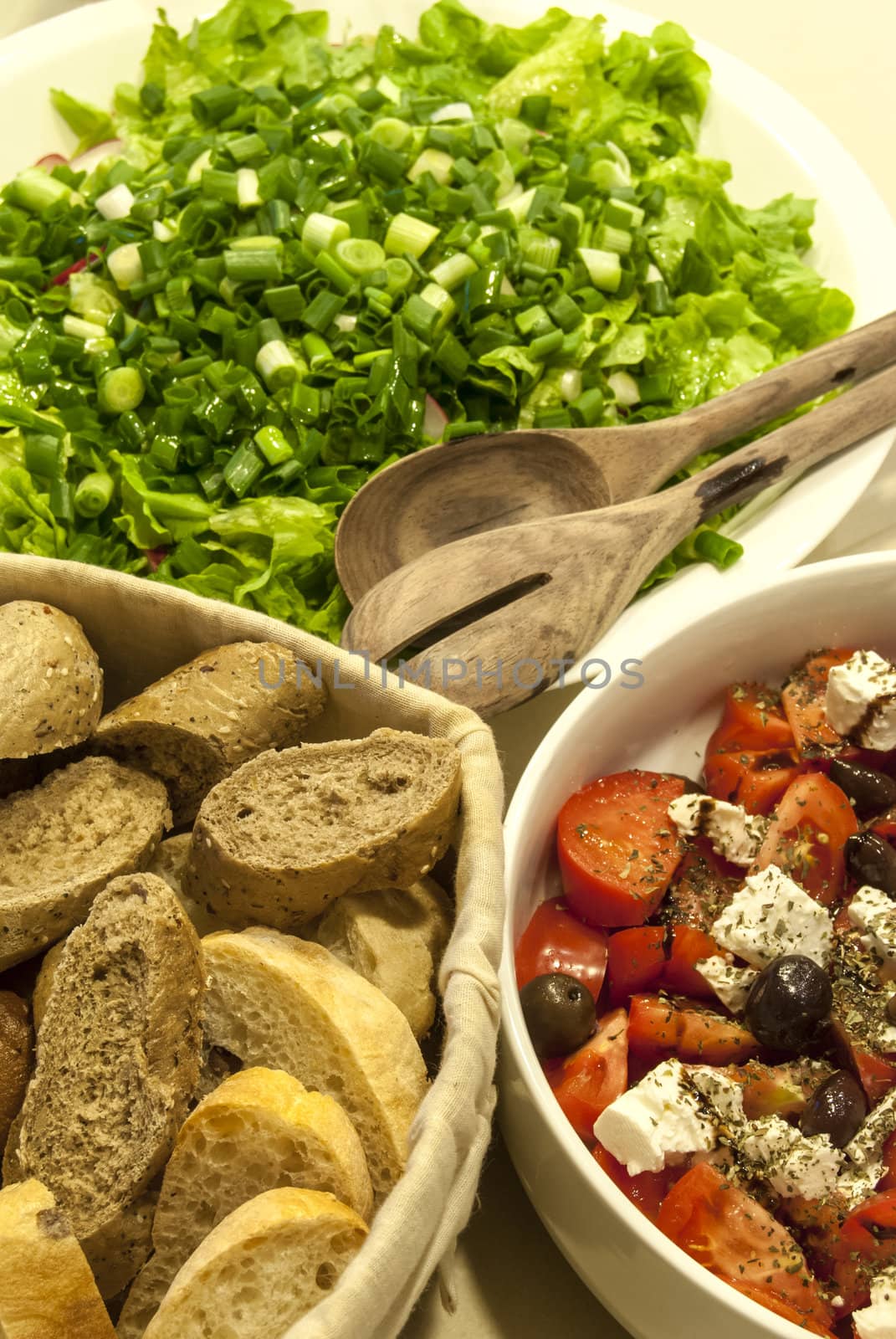 Green salad, chopped  tomatoes, cheese, olives, bread