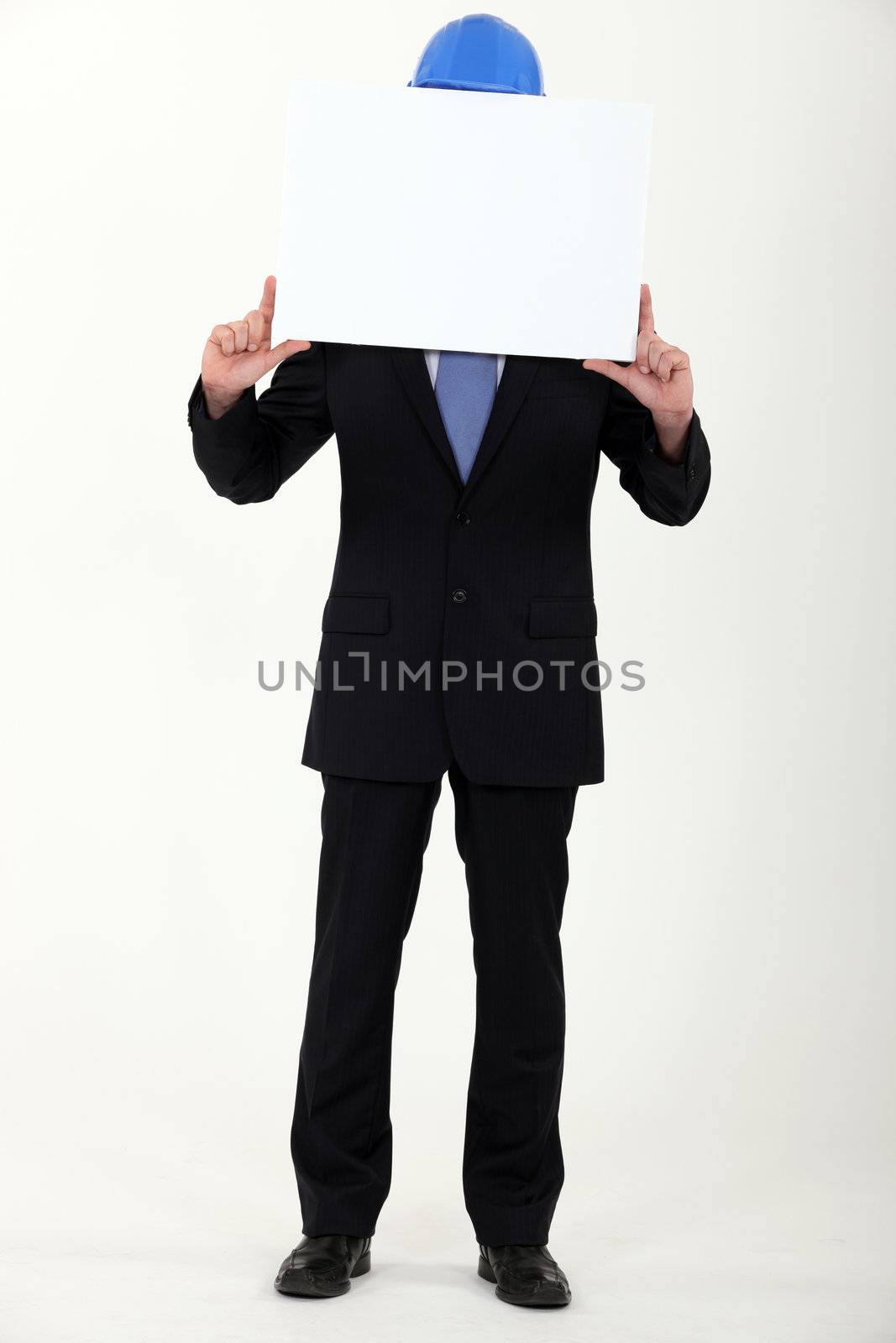 Engineer holding up a blank sign before his face by phovoir