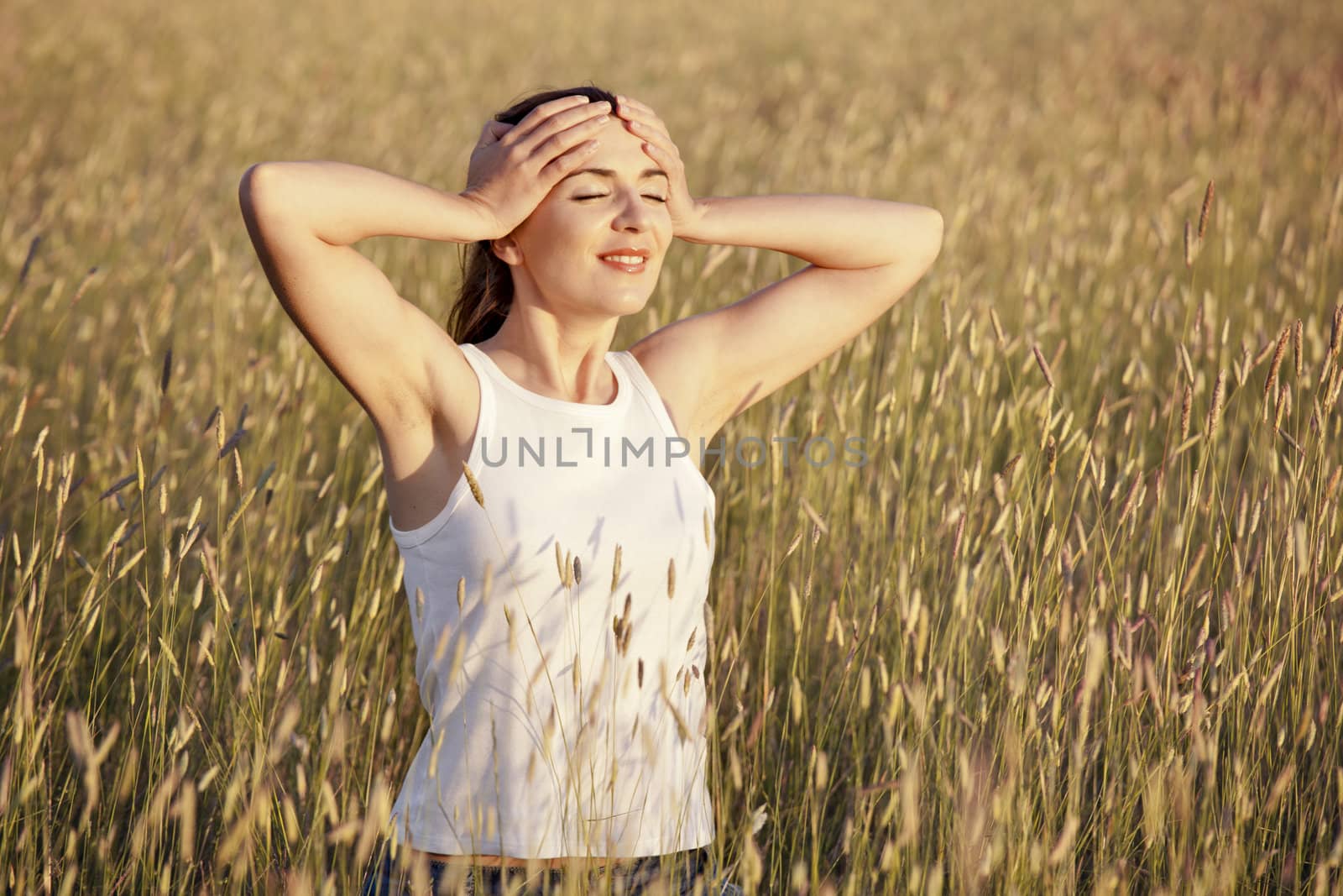 Outdoor portrait of a woman on a meadow releaxing