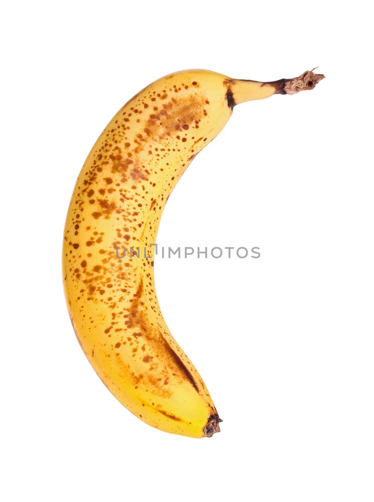 Perfectly ripe, brown-spotted banana isolated against a white background