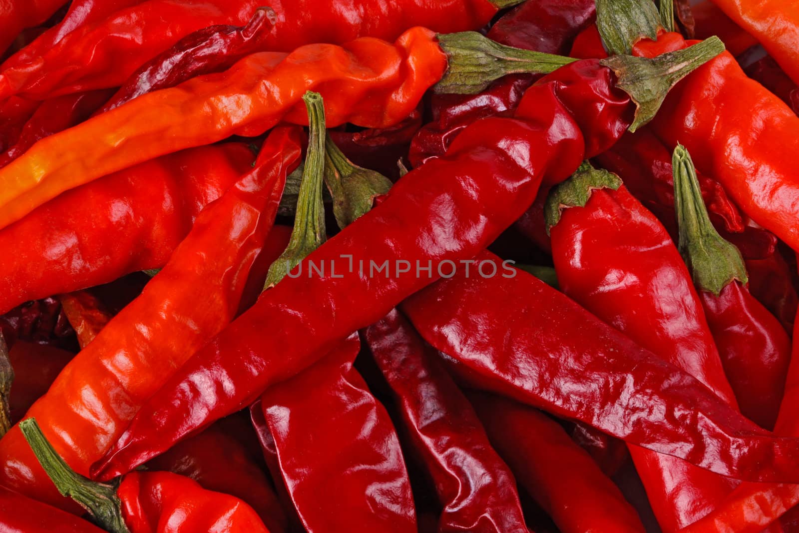 Macro image of dried red hot cayenne chili peppers completely filling the frame