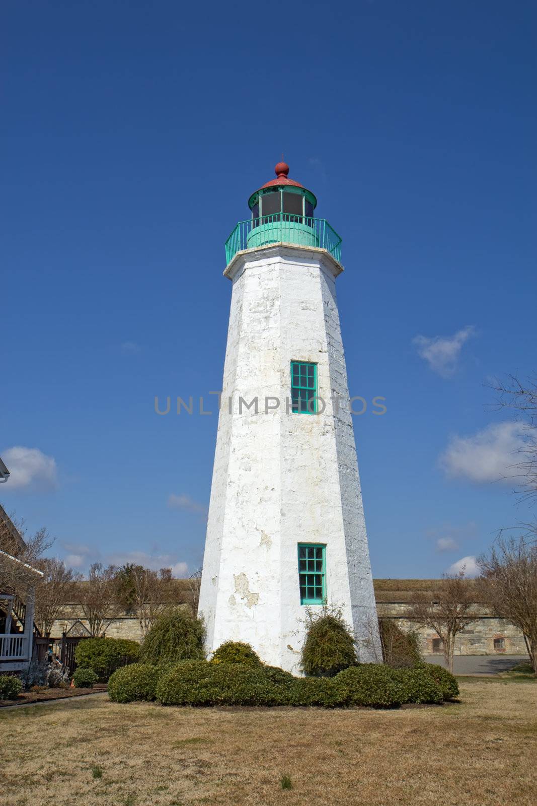 The Old Point Comfort lighthouse, a part of the new Fort Monroe National Monument, in winter against a bright blue sky