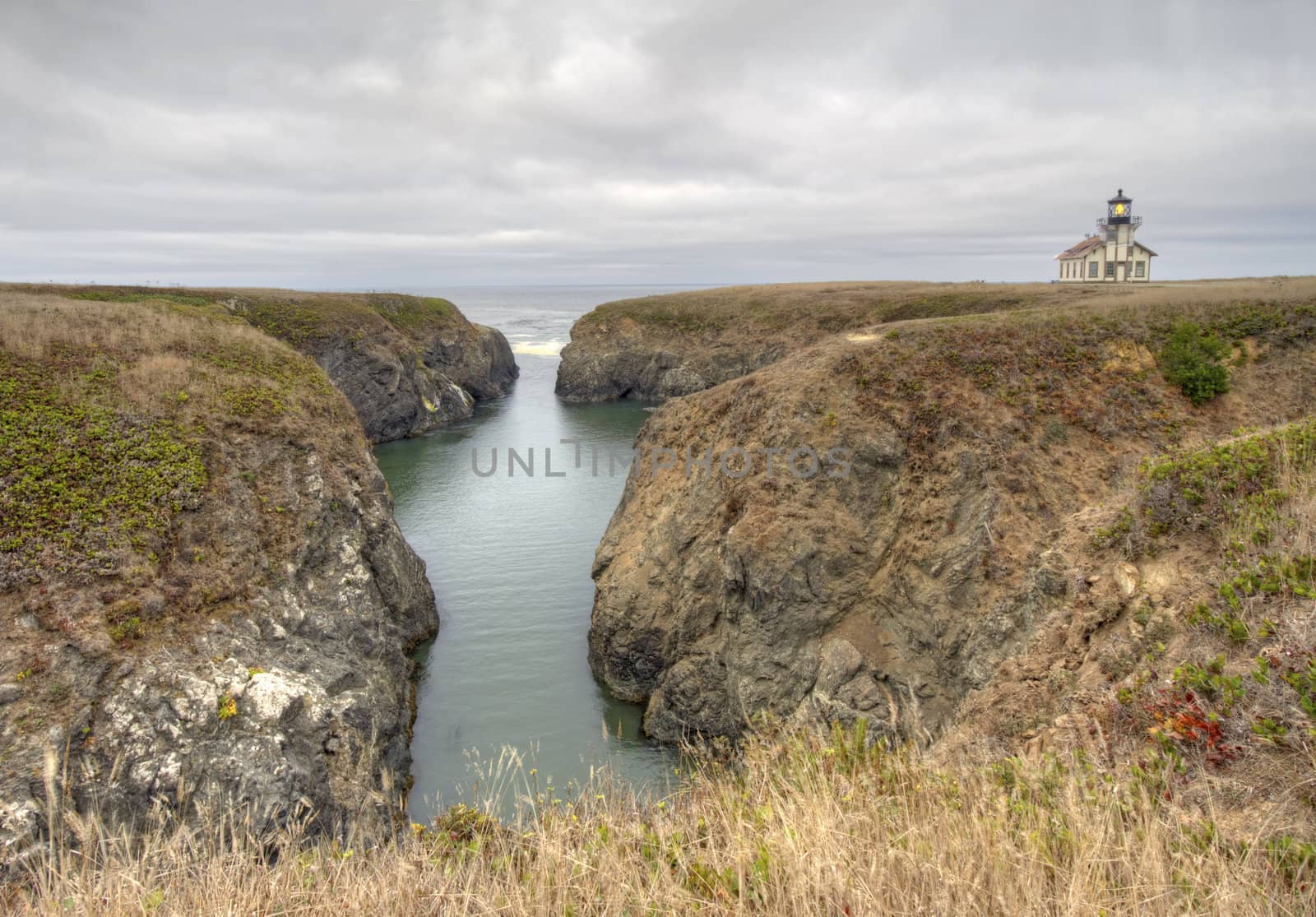 Point Cabrillo lighthouse and rocky coast on a cloudy day by sgoodwin4813