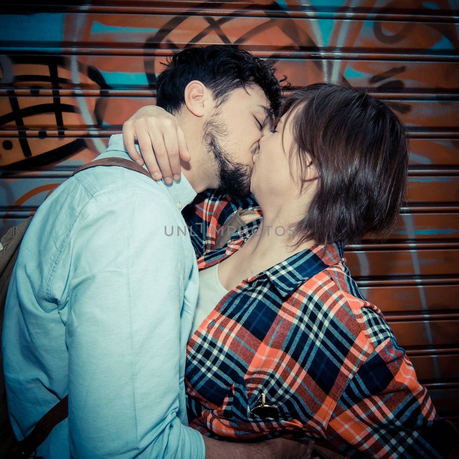 young couple kissing in the street