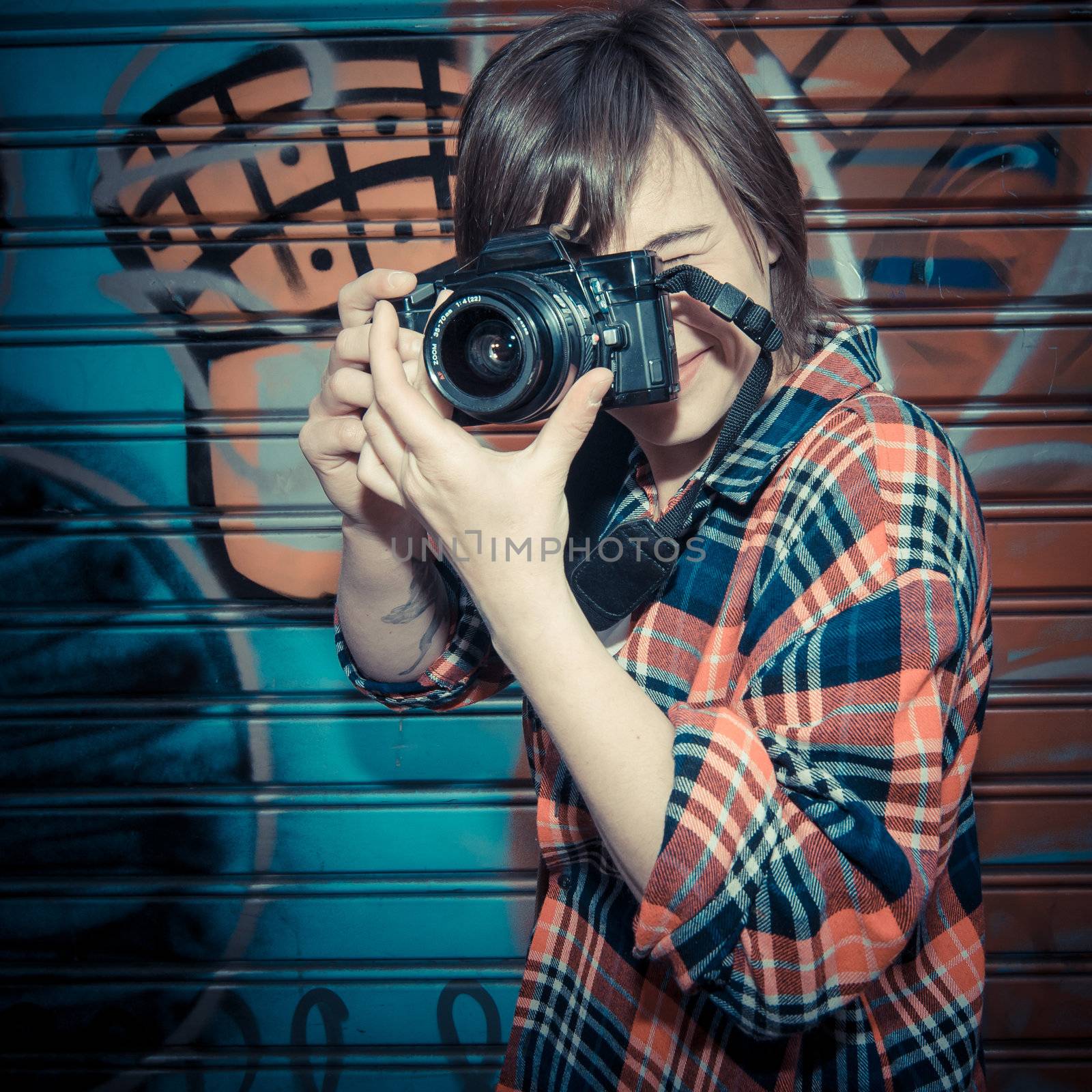 hipster young woman taking photo in the street