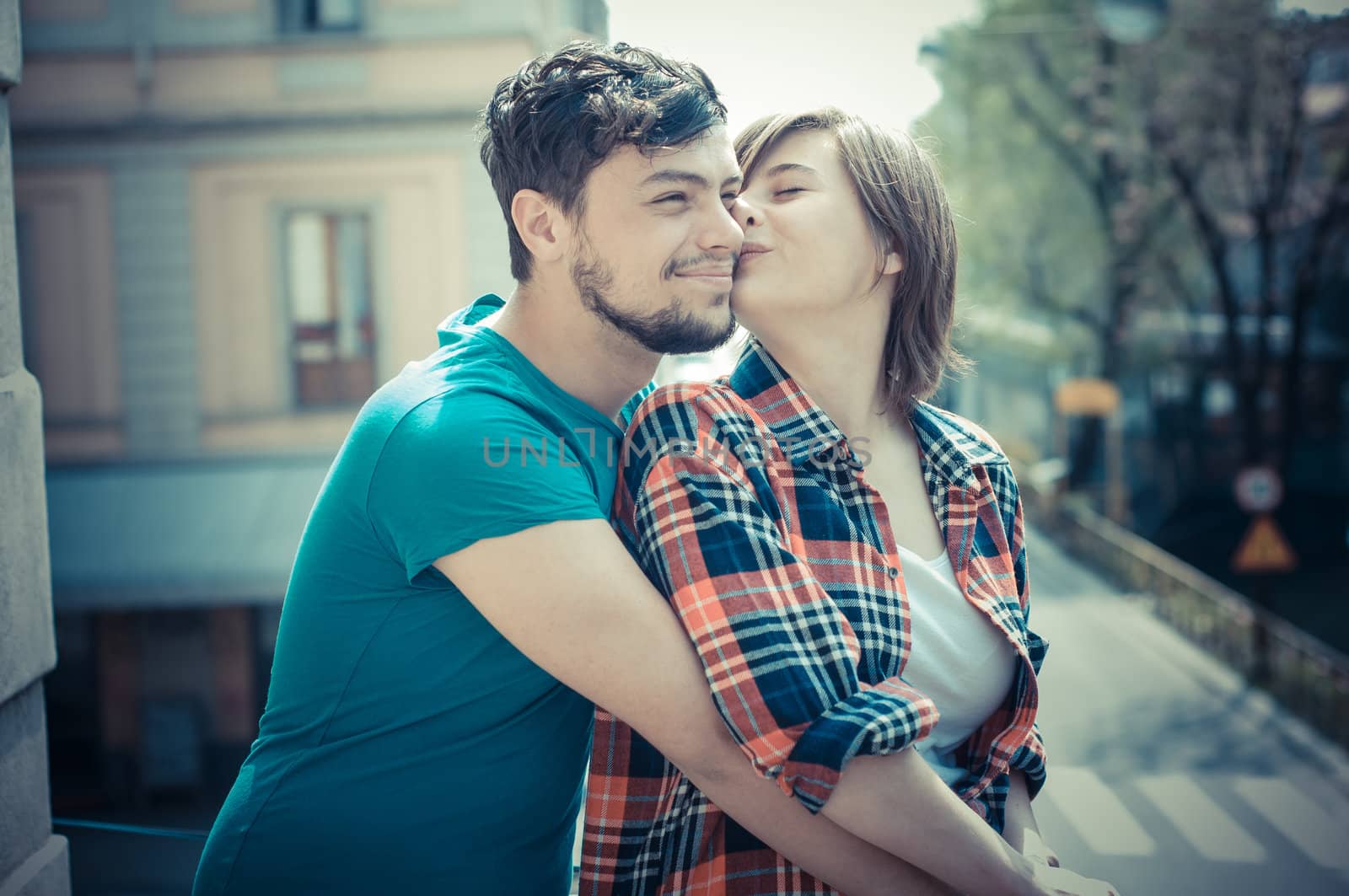 young couple kissing by peus