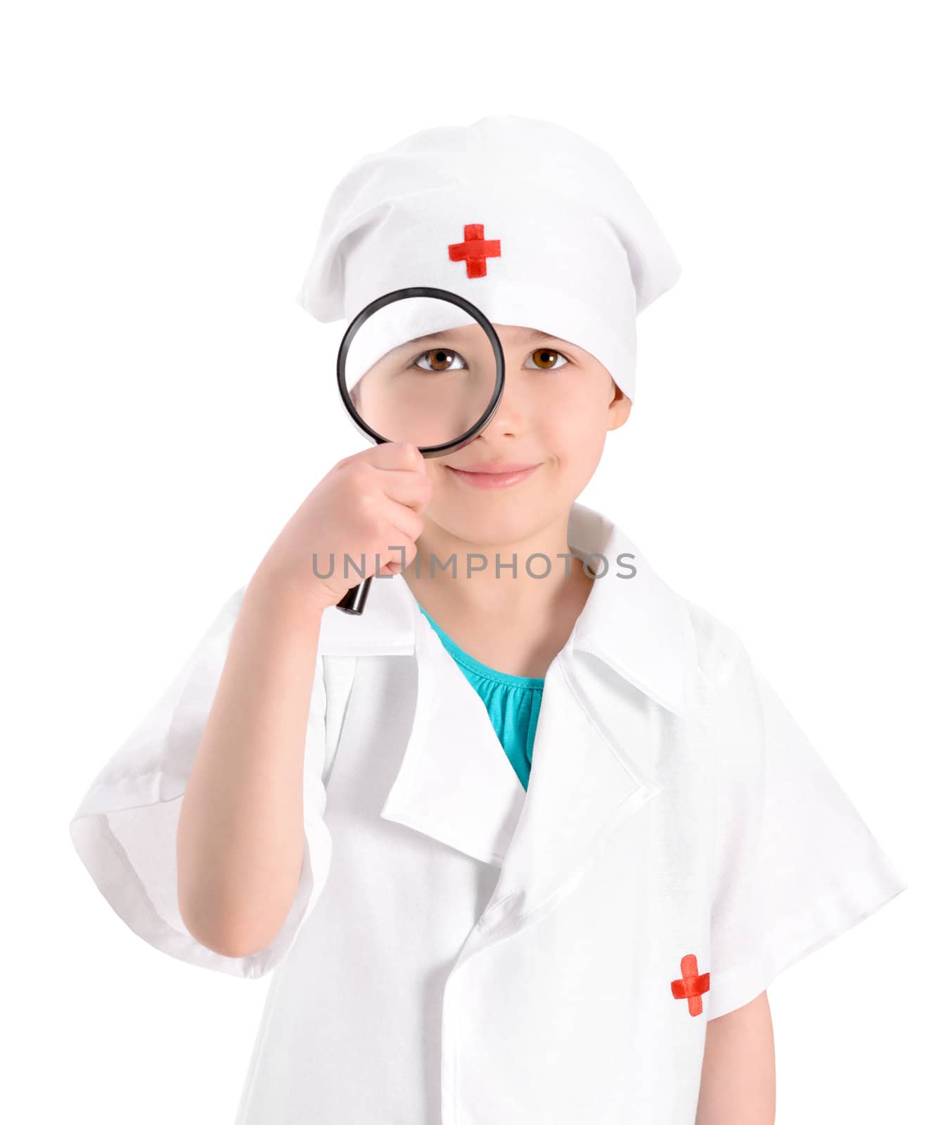 Portrait of a smiling little girl wearing as a nurse on white uniform and holding in right-hand a magnifying glass in front of her eye. Isolated on white background.