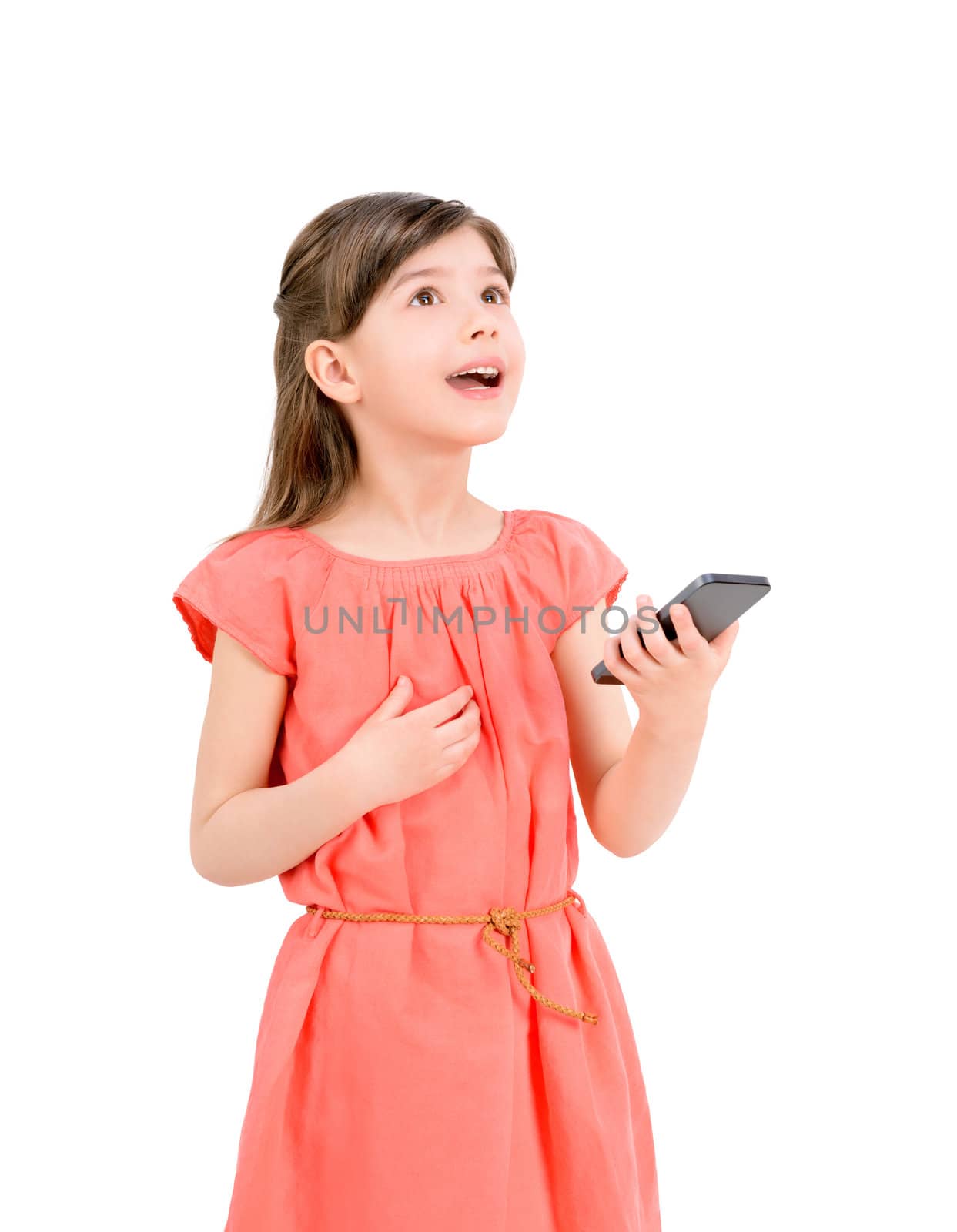 Inspired cute little girl in red dress looking up and holding in her hand mobile phone. Isolated on white background.