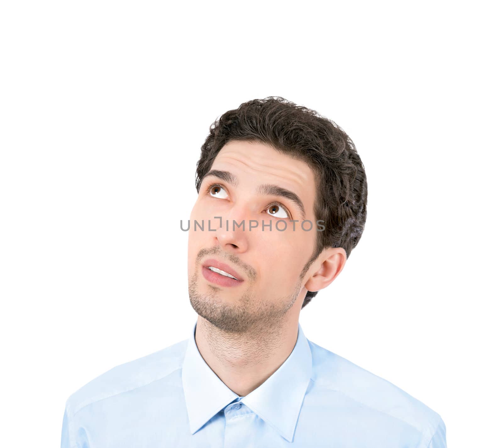 Handsome young businessman looking up at copyspace. Isolated on white background