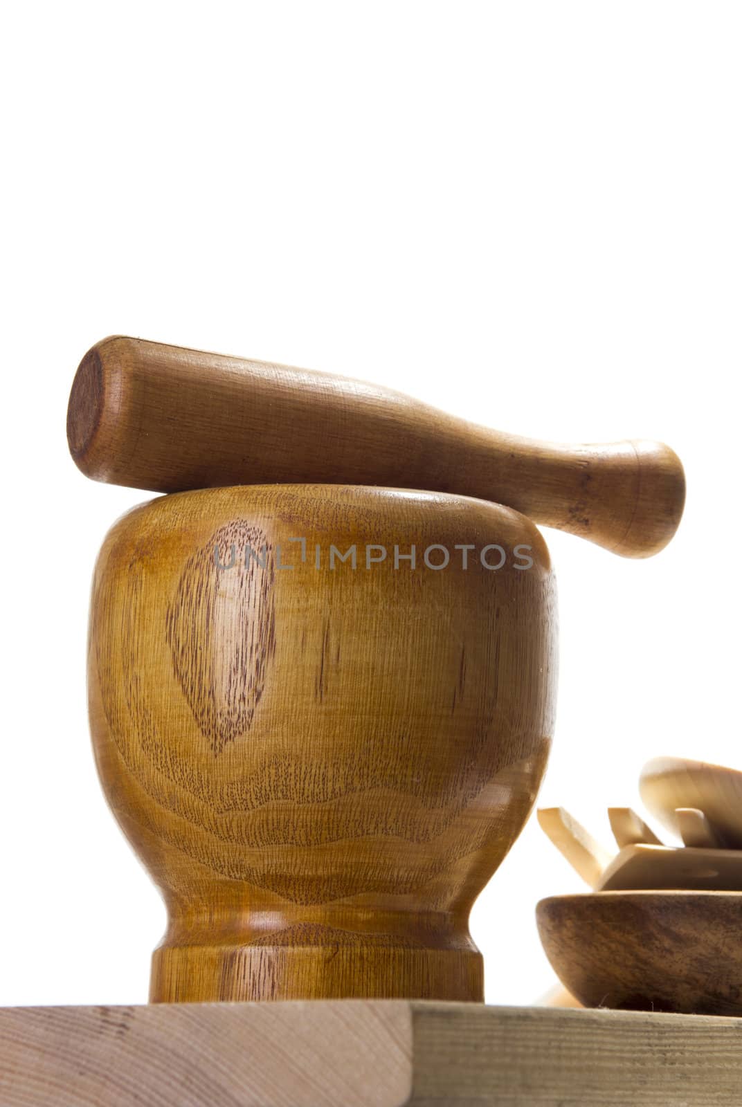 Wooden mortar and pestle on white background. Traditional kitchen equipment.