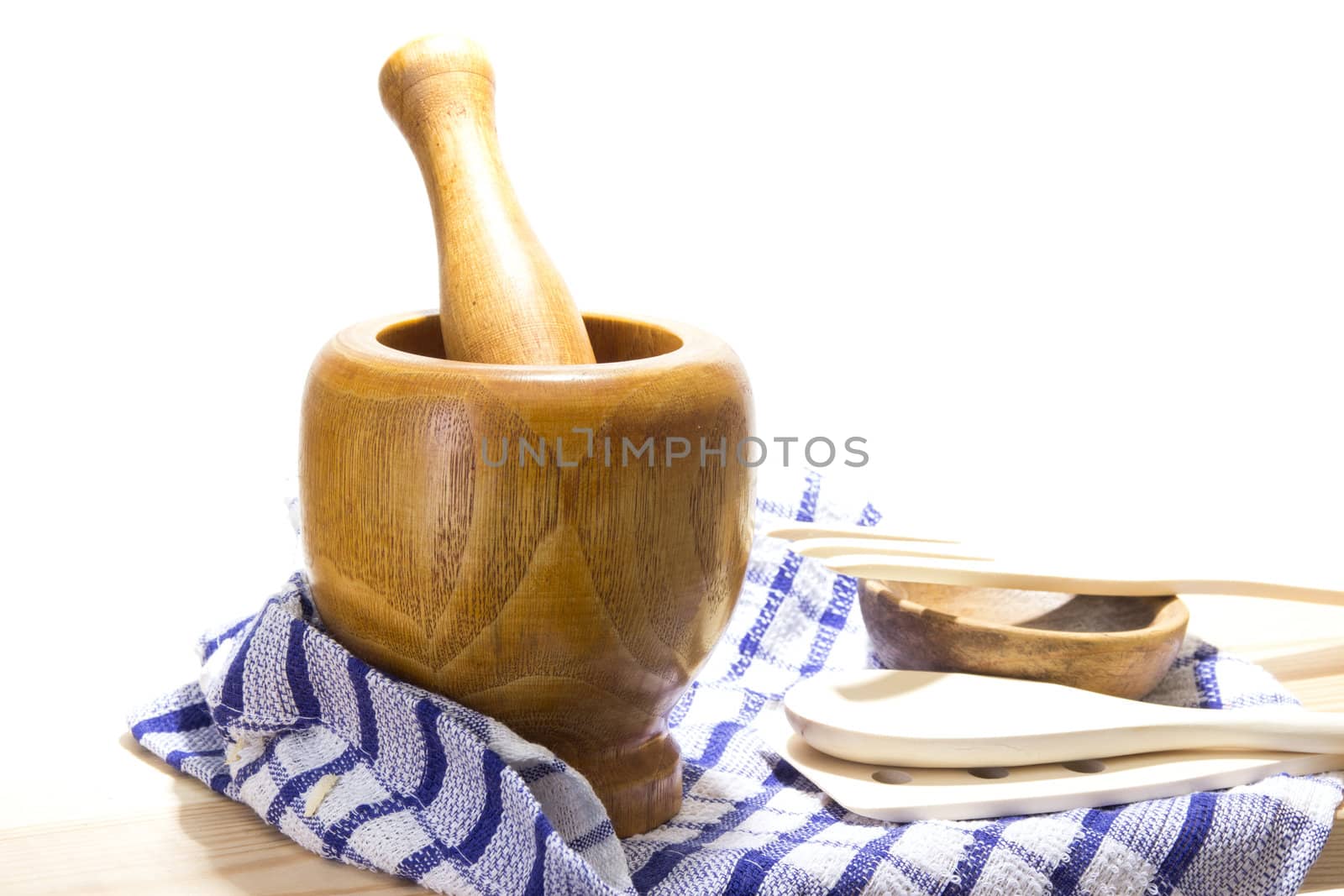 Wooden mortar and pestle on white background. Traditional kitchen equipment.