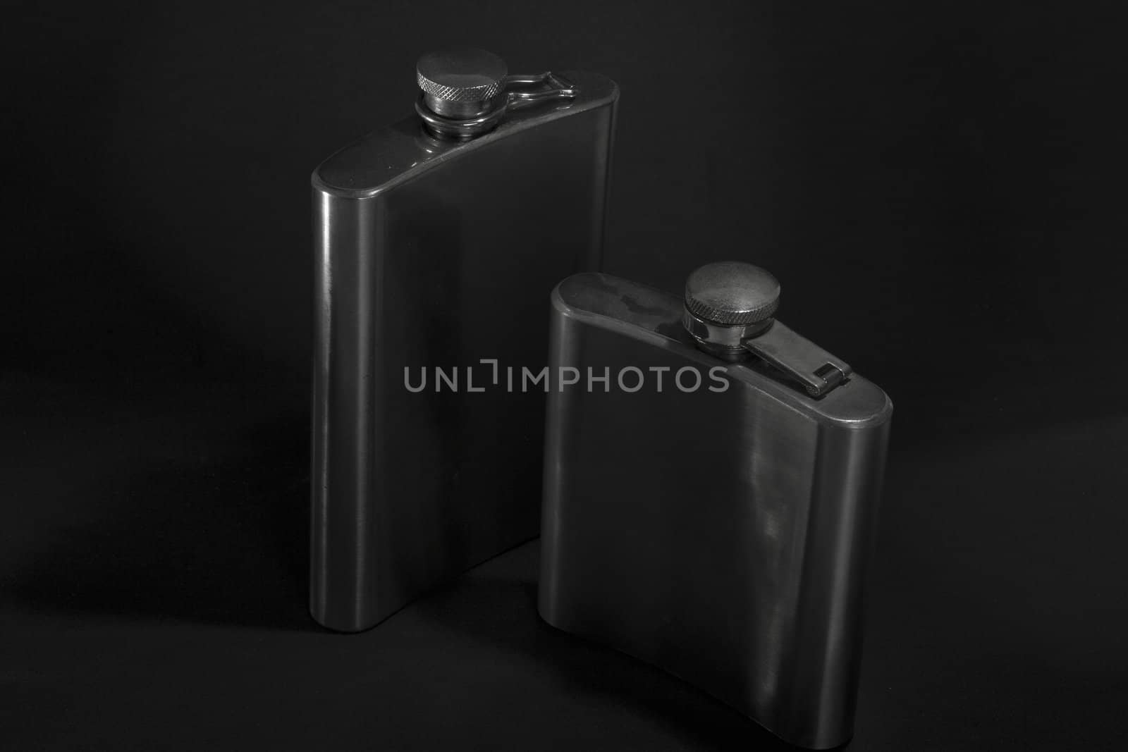 One of the most favorite men's toy - a metal flask for alcoholic beverages. Two used jars of stainless steel for whiskey or brandy