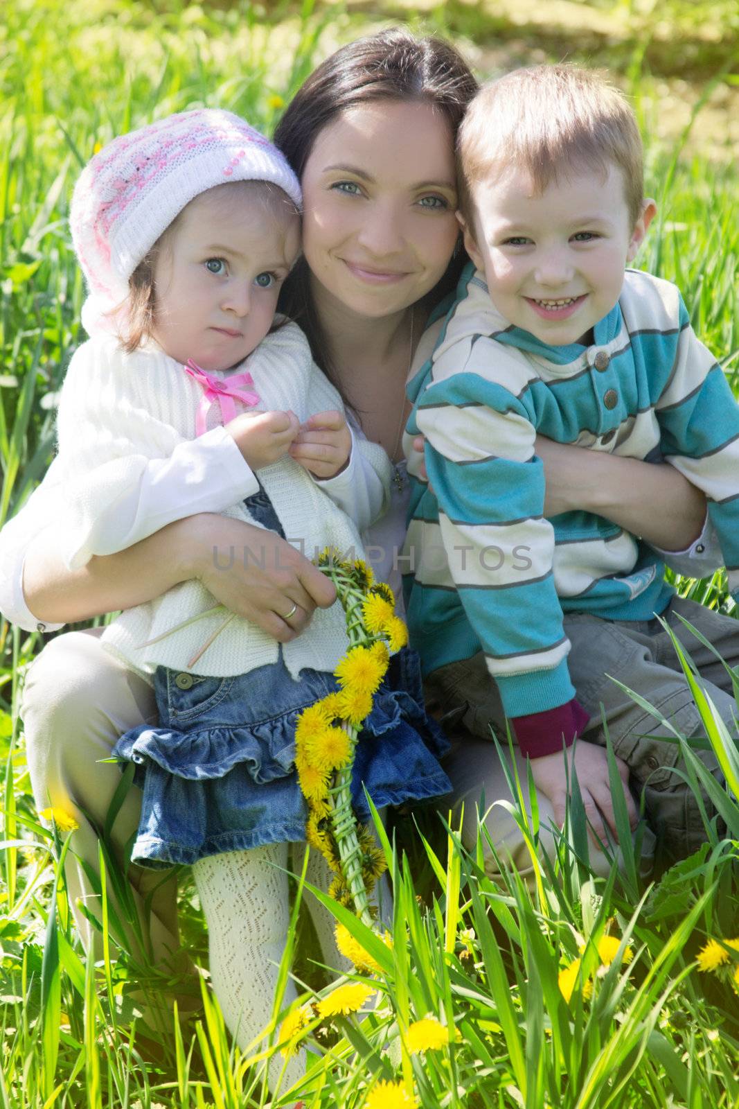 Happy mother and two children outdoor in spring