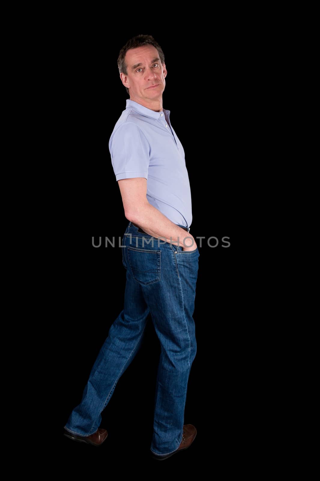 Middle Age Man Looking Backwards Over Shoulder Black Background