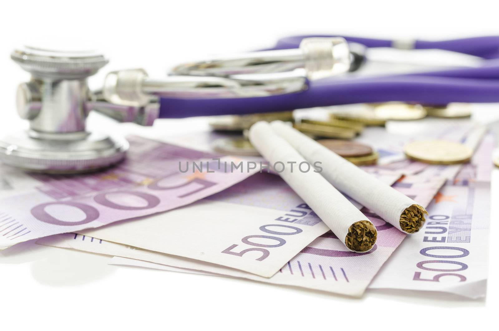 Cigarettes and stethoscope on Euro money. With copy space. Concept of health and financial damage smoking makes.