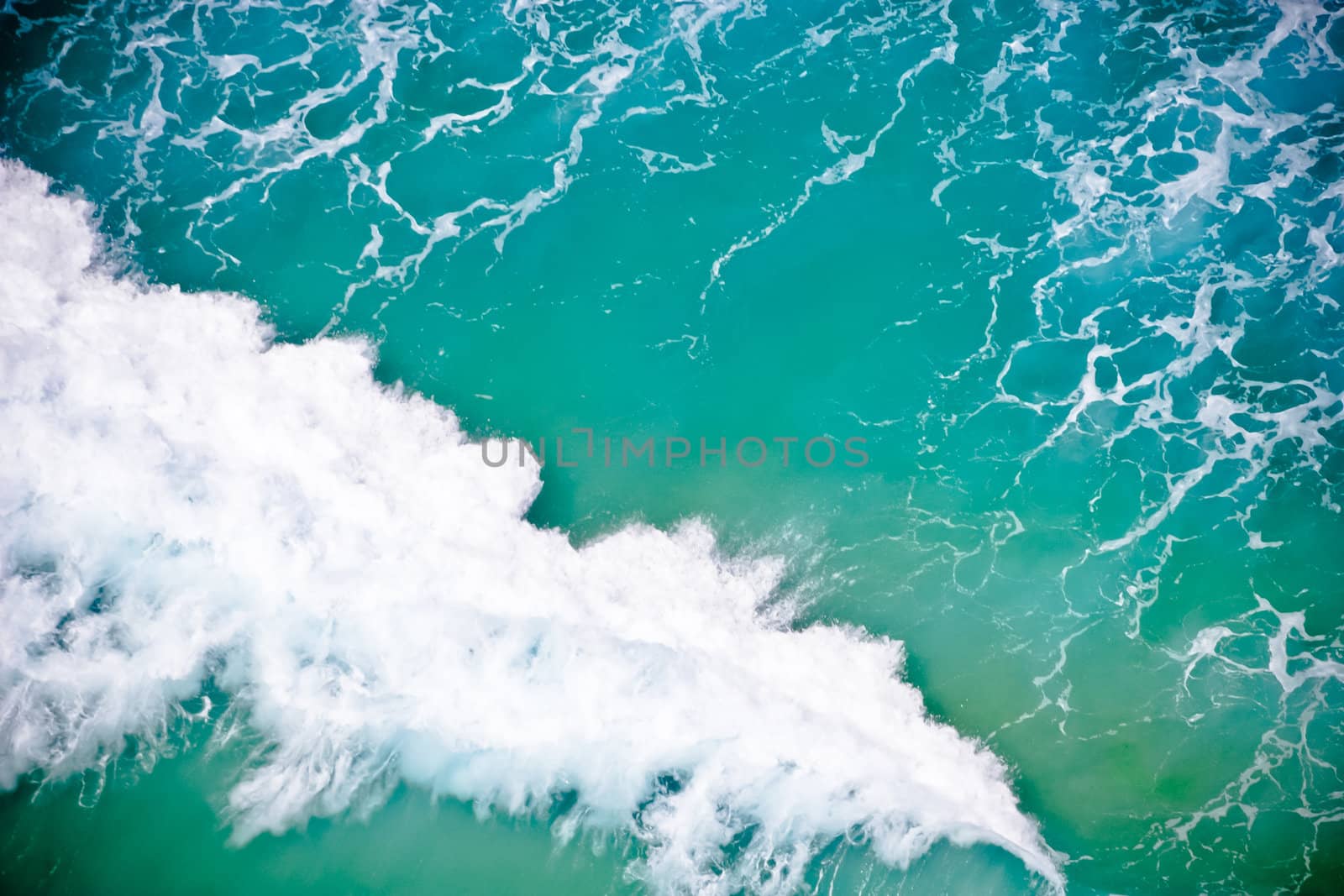 Sea water with a foamy wave, high angle by jrstock