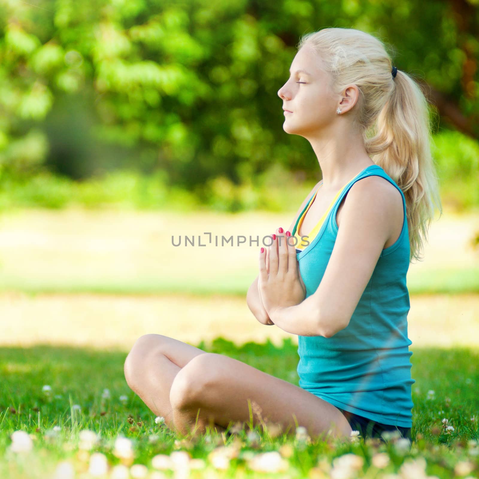 Young woman doing yoga exercise by markin