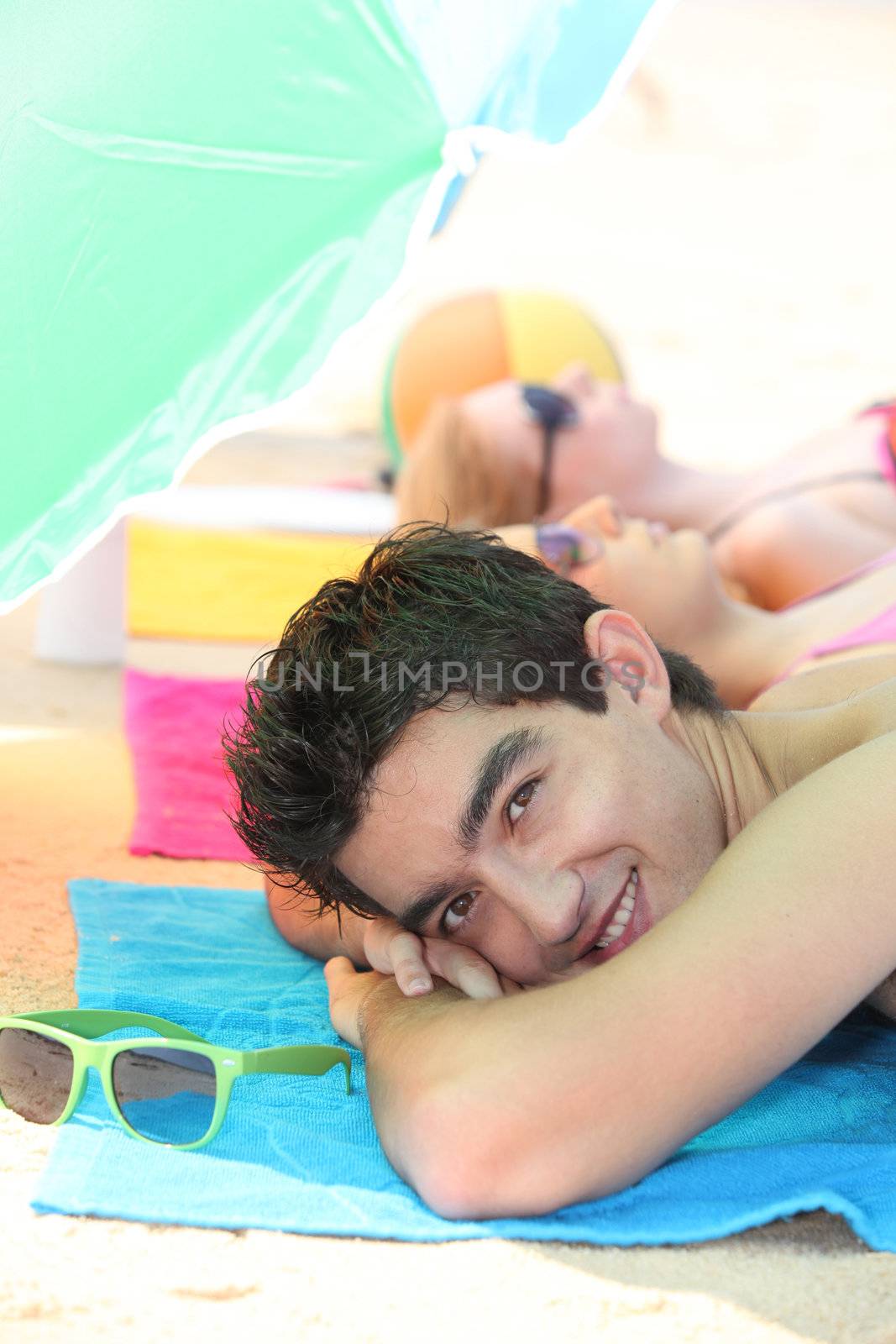 Teenagers lying on the beach