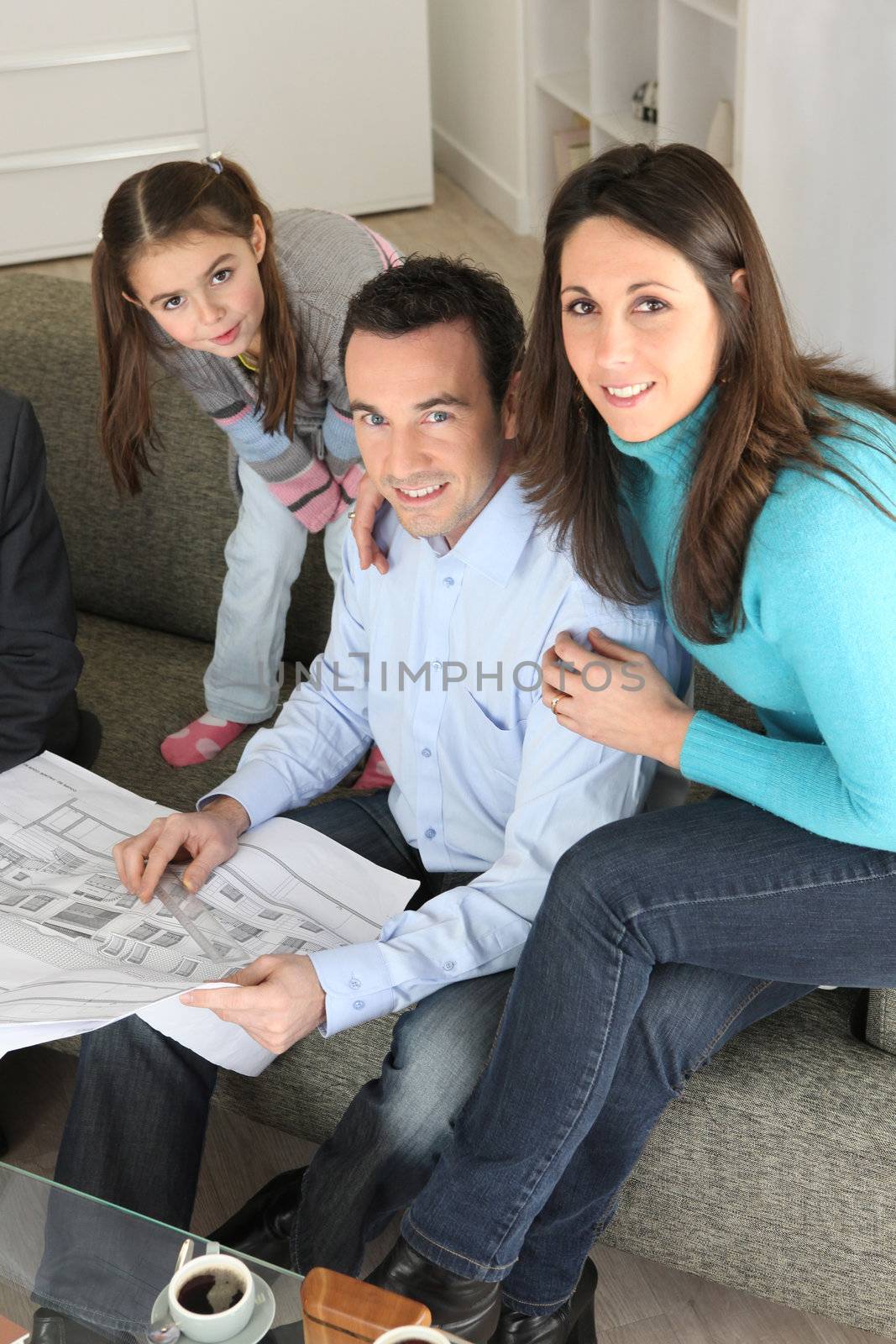 Family watching architectural blueprint