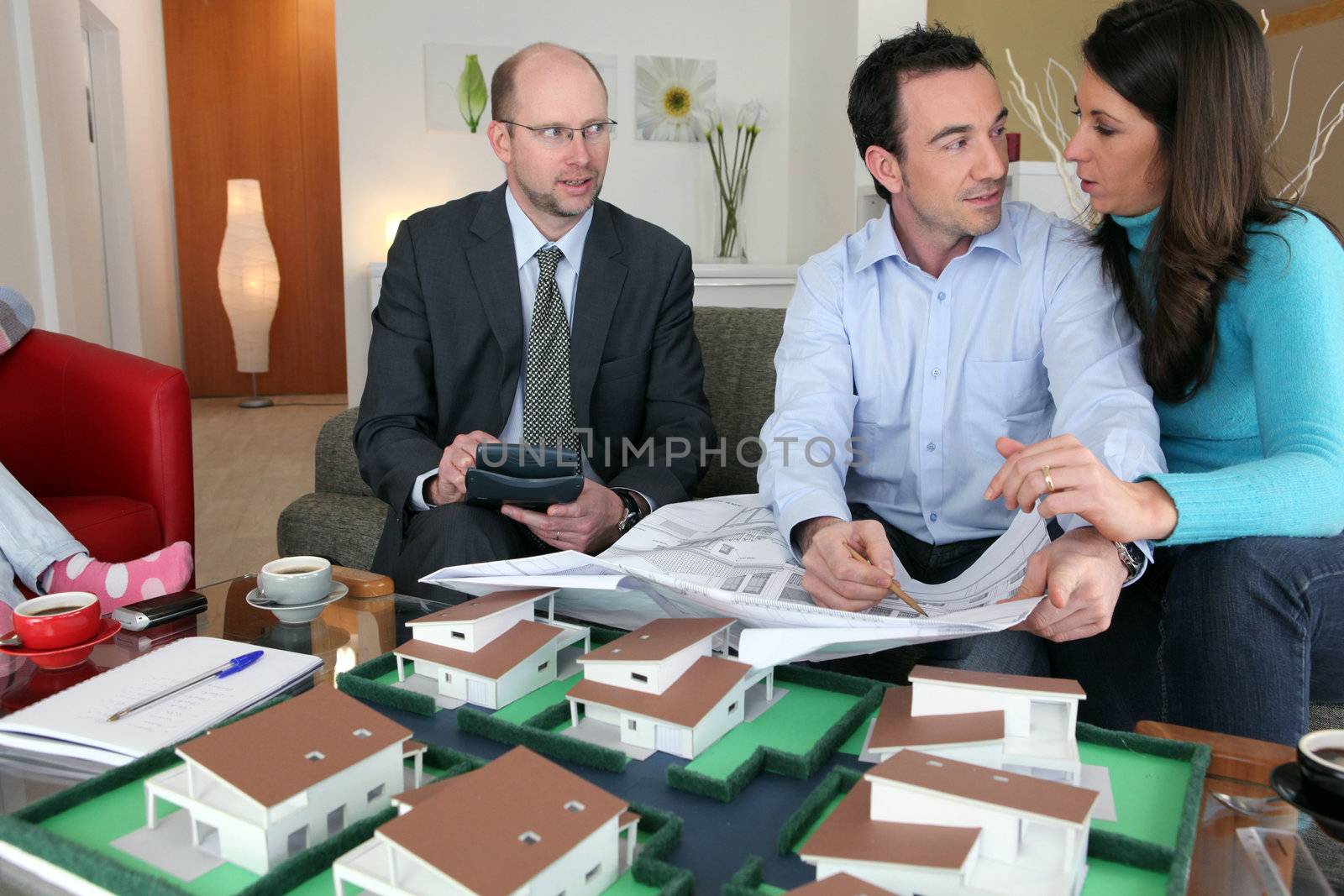 Property salesman sat with couple