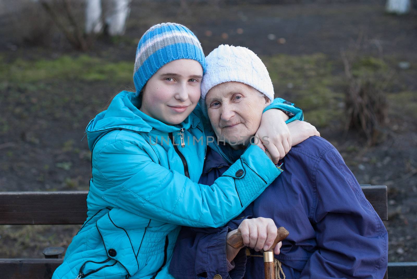 Granddaughter embracing her grandmother on the street