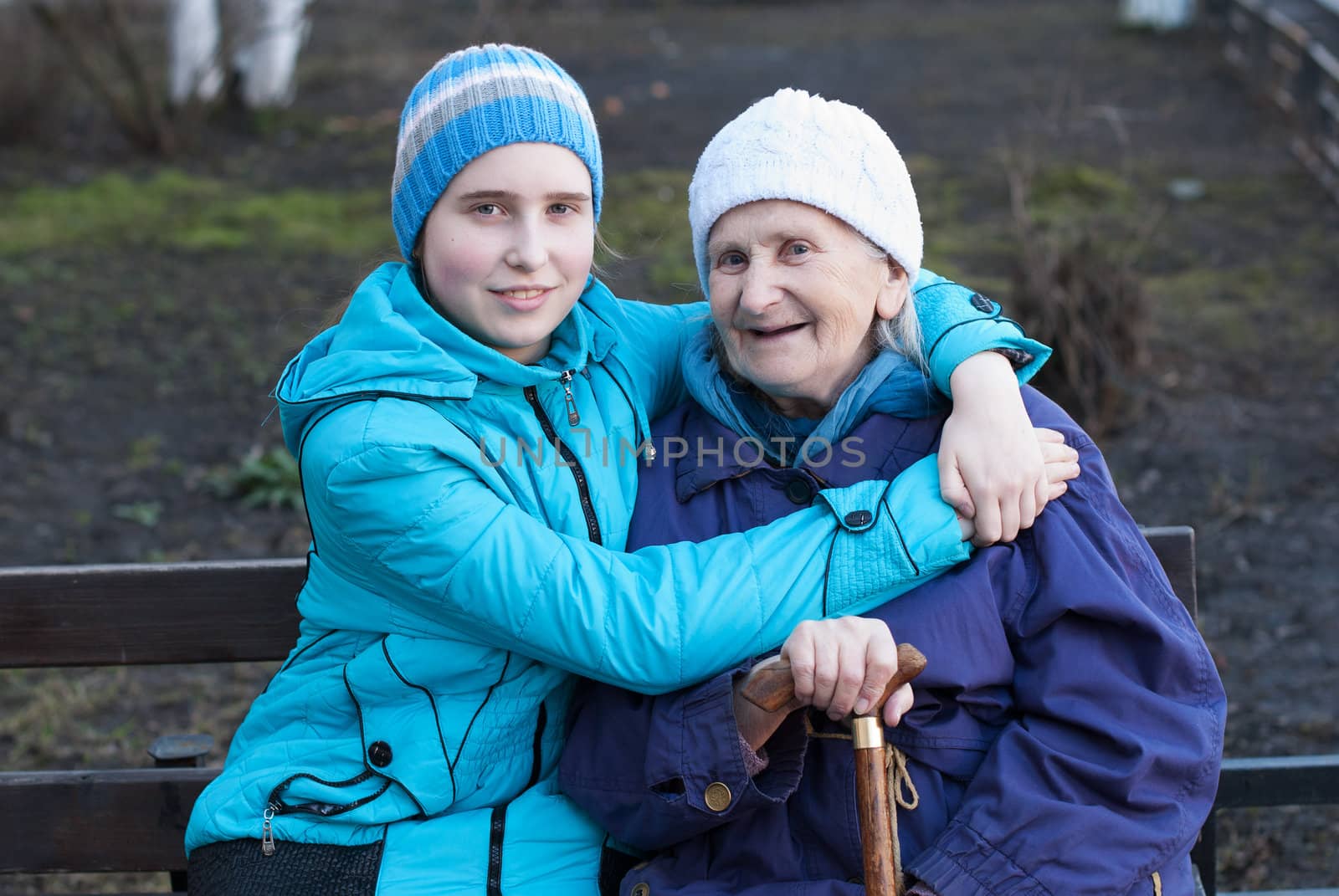 Granddaughter embracing her grandmother on the street