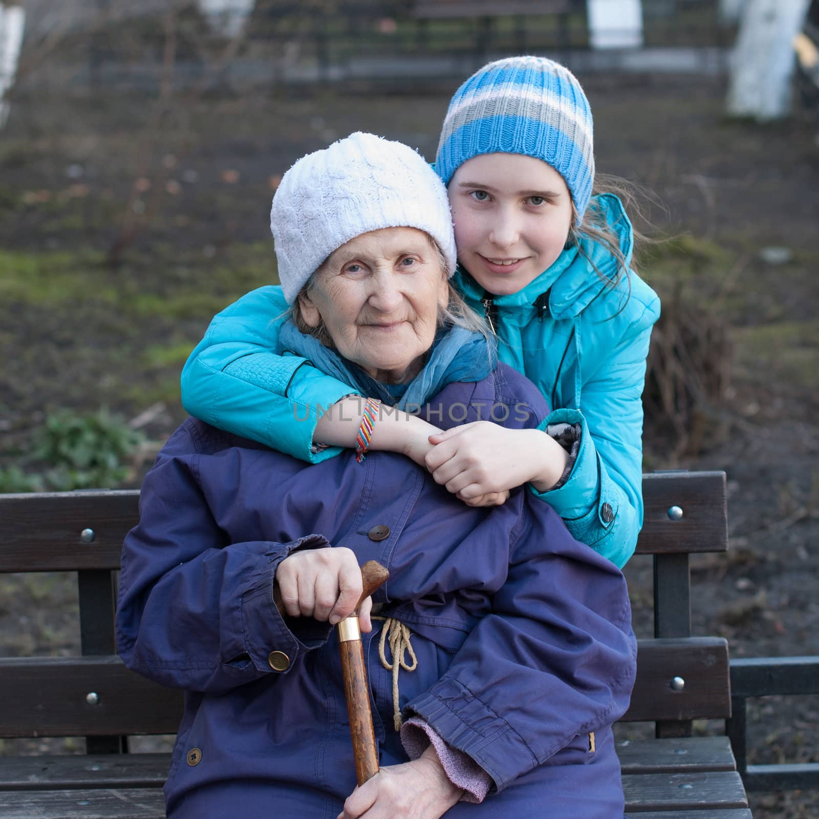 Granddaughter embracing her grandmother by raduga21