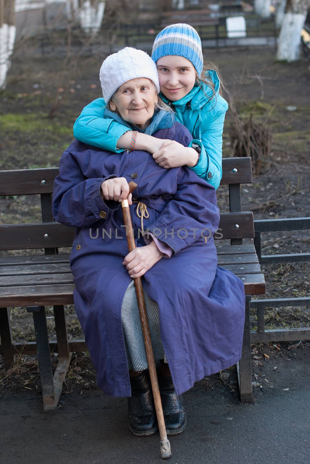 Granddaughter embracing her grandmother on the street