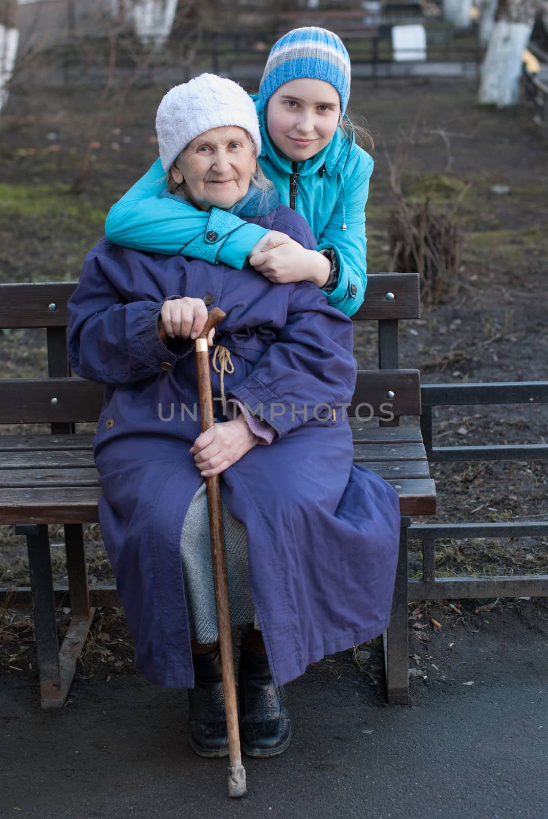 Granddaughter embracing her grandmother on the street